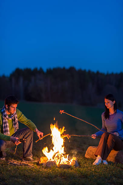 istock Couple cook by bonfire romantic night countryside 177327097