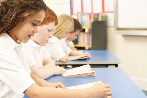 istock Group Of Children Reading Books In Classroom 177327612