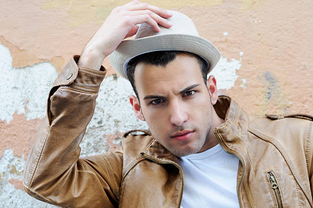 istock Attractive young man with a hat in urban background 177327722