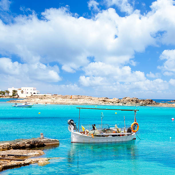 Els Pujols beach in Formentera Els Pujols beach in Formentera with traditional fishing boat in summer day formentera island stock pictures, royalty-free photos & images