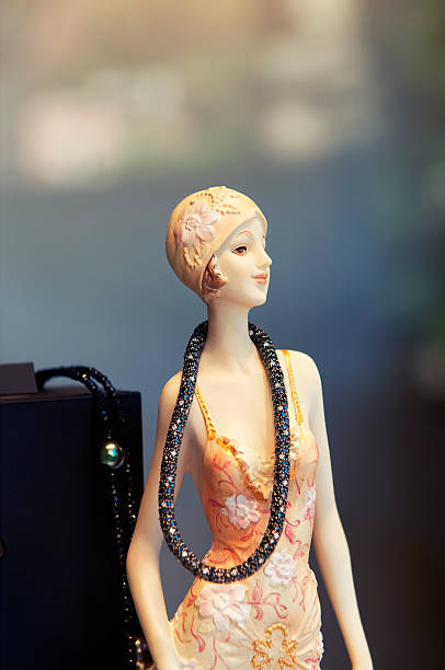 closeup of mini mannequin with pink dress in fashion store for women