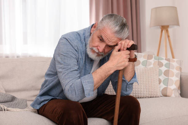 istock Senior man with walking cane sitting on sofa at home 1773293268