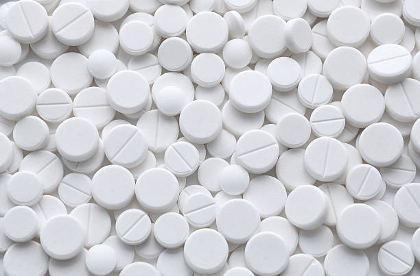 Pills background White pills (tablets) background. Medicine objects. aspirin photos stock pictures, royalty-free photos & images