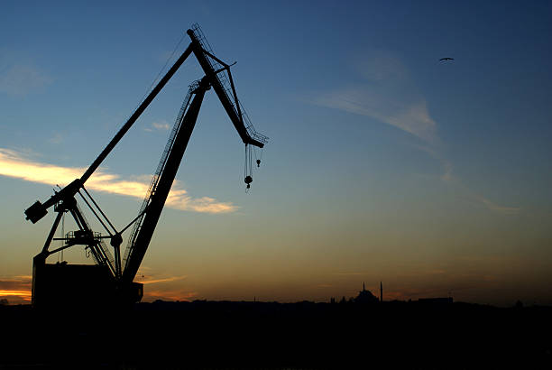 istock crane silhouette on the city 177330108