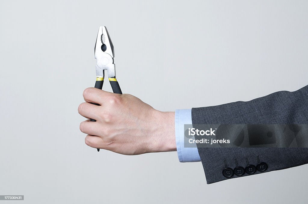 Holding a tool A man in a suit holding a tool 20-24 Years Stock Photo