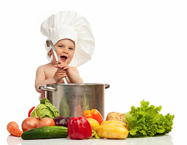 istock Little boy in chef's hat with ladle, casserole, and vegetables 177330803