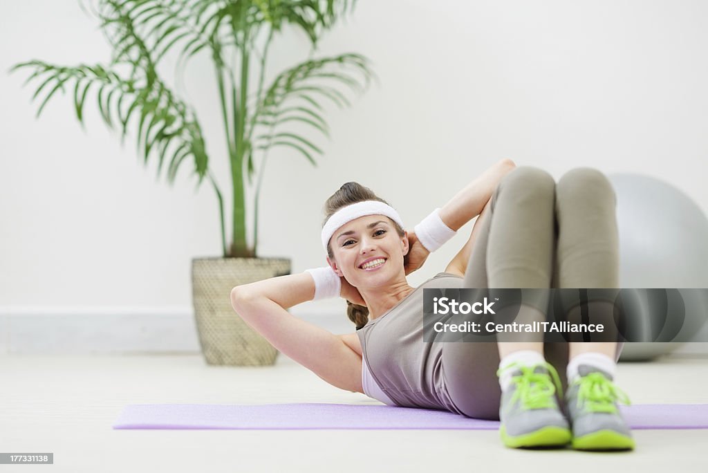Happy healthy woman doing abdominal crunch Active Lifestyle Stock Photo