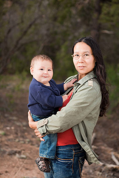 Native American mother and her mixed race baby boy enjoying a day in the nature
