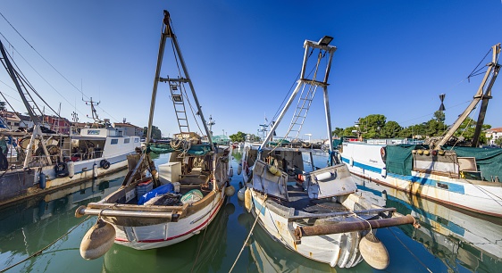Picture of fishing boats in an industrial harbor in the Croatian coastal town of Novigrad during the day