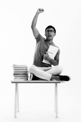 B&W studio shot of male student shouting of success