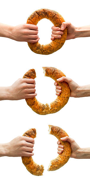 Set of hands breaking ring bread stock photo