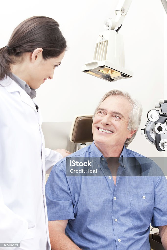 Optometrist performing an eyesight test examination  Optometrist and patient in clinic. Eye Exam Stock Photo