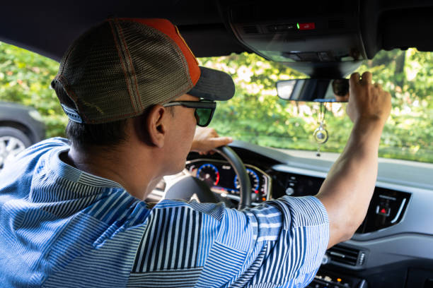 istock Man sitting behind the wheel checking the rearview mirror inside the car. 1773358996