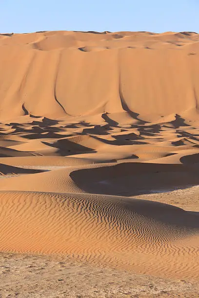 Huge sand dunes higher than buildings in the Empty Quarter desert in the United Arab Emirates