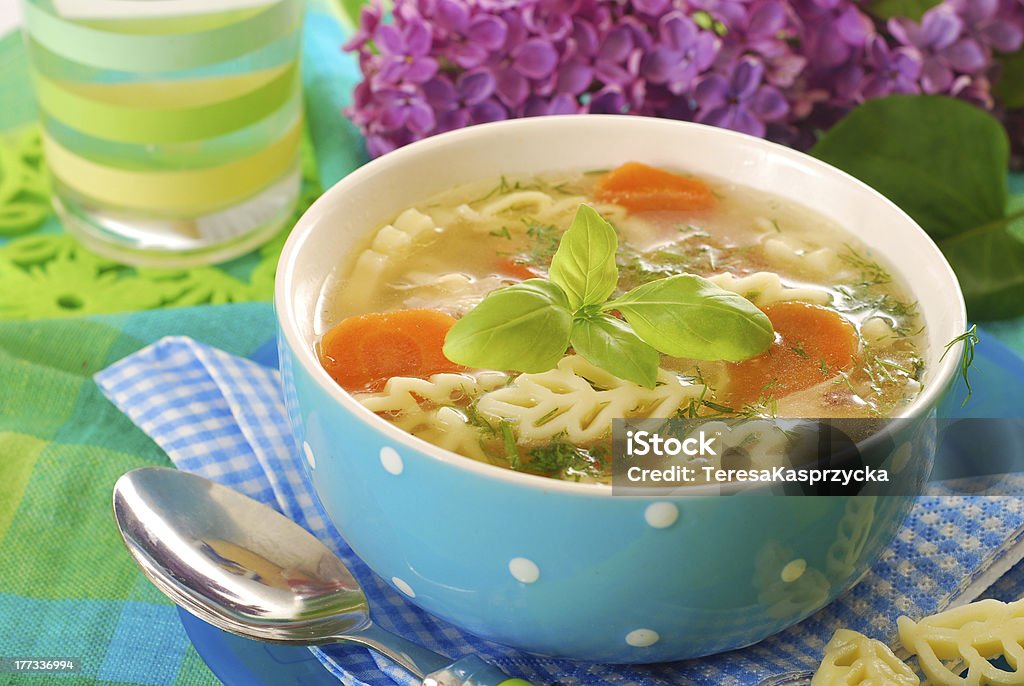 chicken soup with noodle bowl of clear chicken soup with ear shape noodle Basil Stock Photo