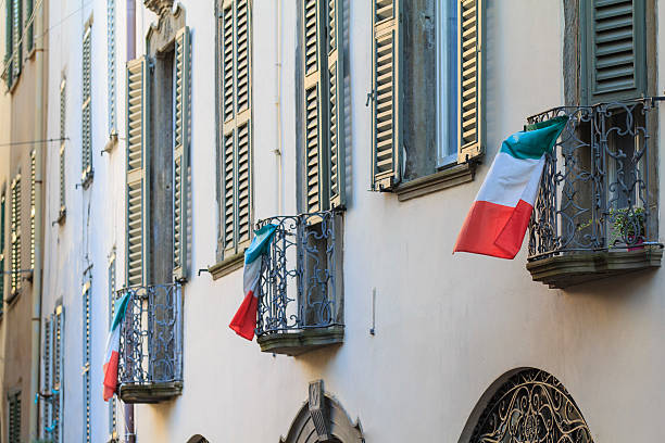 National italian flag waving on an ancient wall in Tuscany.