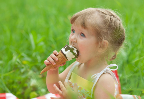 little girl eating ice cream outdoor
