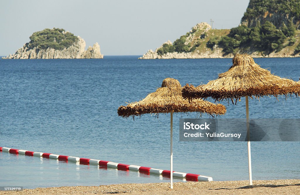Umbrella on a sandy beach Aegean Sea Stock Photo