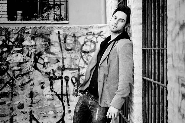 istock Attractive young man in urban background 177340093
