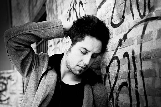 istock Attractive young man in urban background 177340098