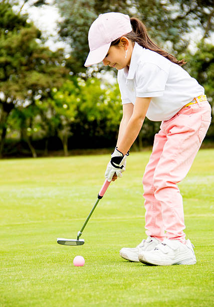 Female golfer hitting the ball stock photo