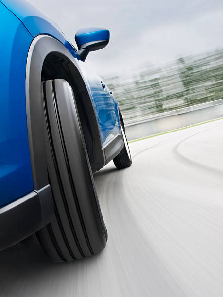 Close-up of car's wheel in a speedy turning stock photo