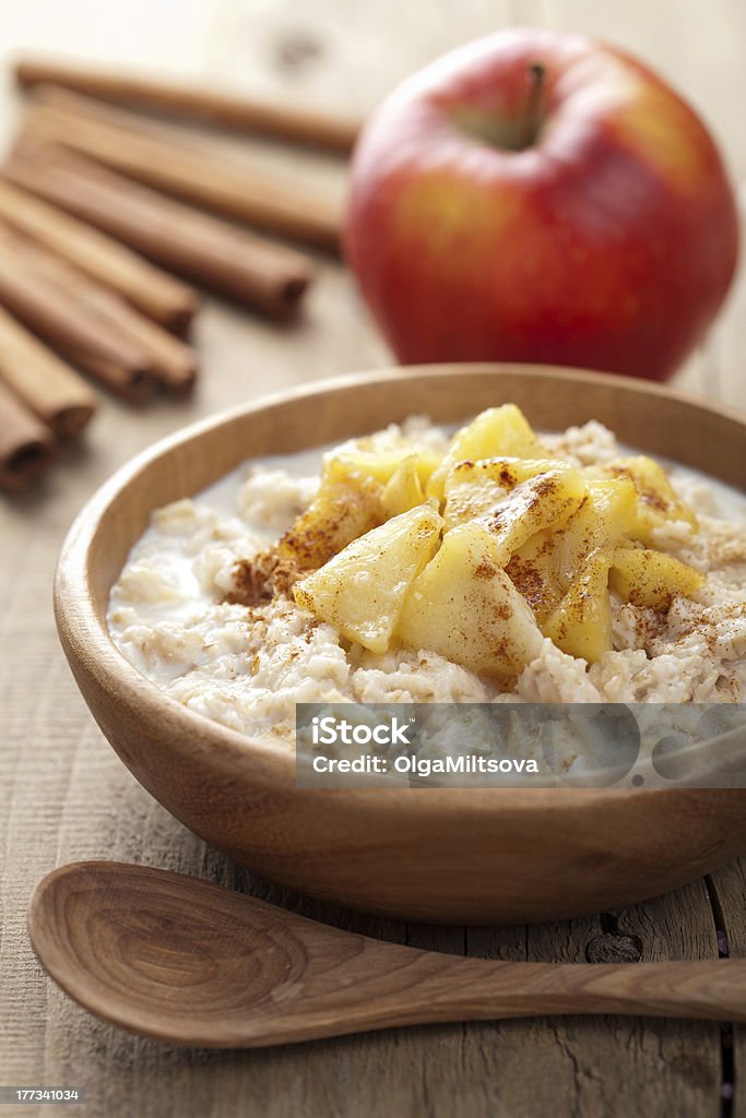 Oatmeal, caramelized apple, and wooden dining ware cereal with caramelized apple Apple - Fruit Stock Photo