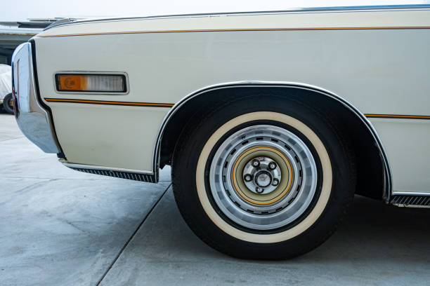 Close up view of 1970's vintage American car with classic white wall tires.
