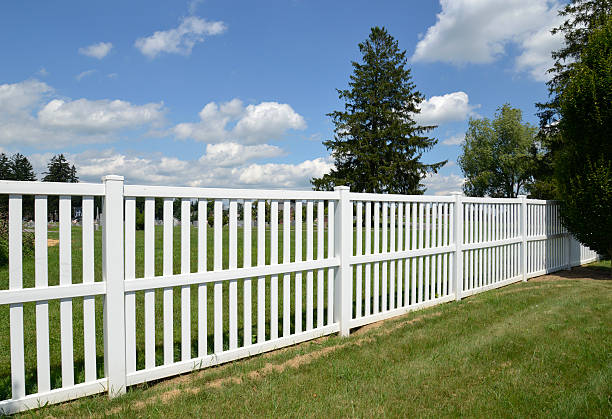 istock white vinyl fence by green lawn 177342211