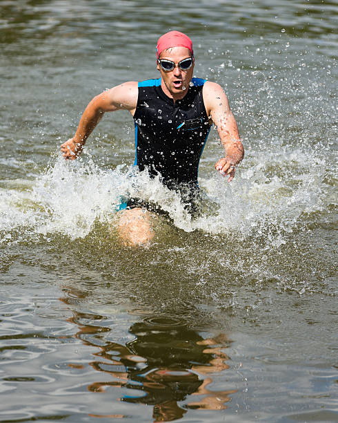 istock triathlete is running out of the water 177342514