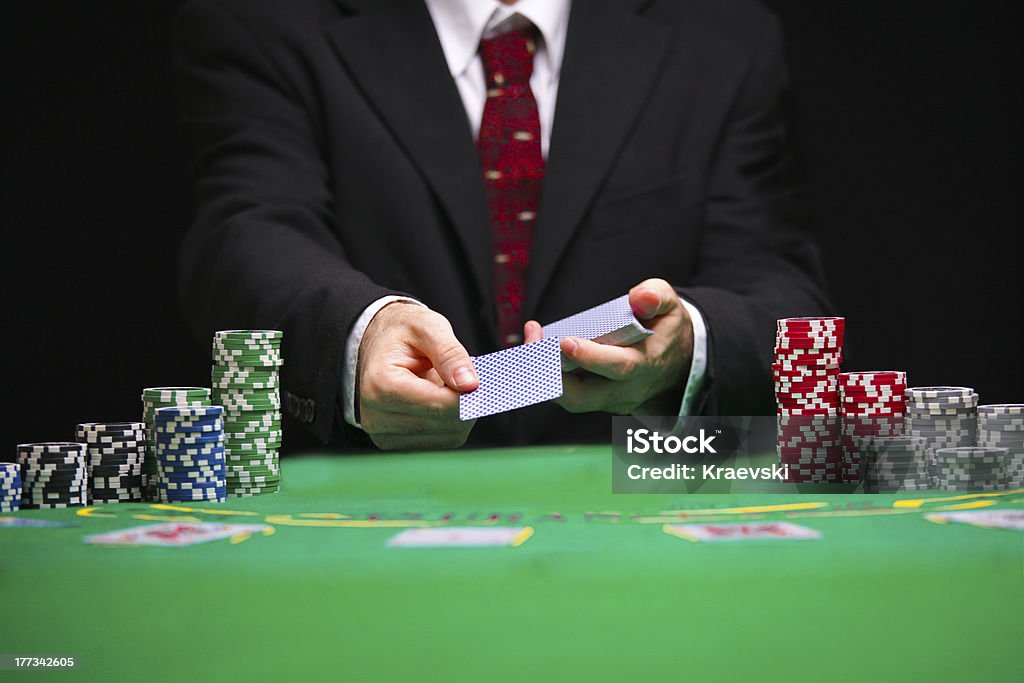 Blackjack Card game respectable casino worker in a tuxedo with a red tie serving  cards Casino Worker Stock Photo
