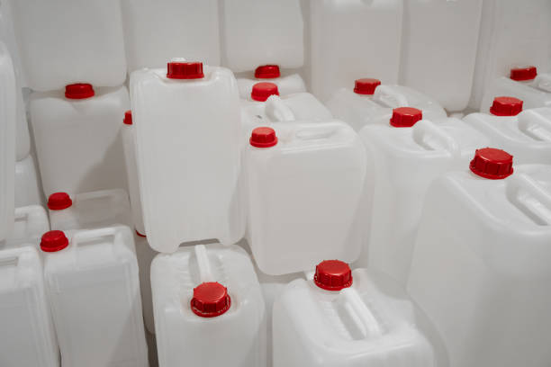 istock Empty white plastic canisters. for liquid refill bottles and cans for household in a hardware warehouse store. red plastic cork caps 1773433335
