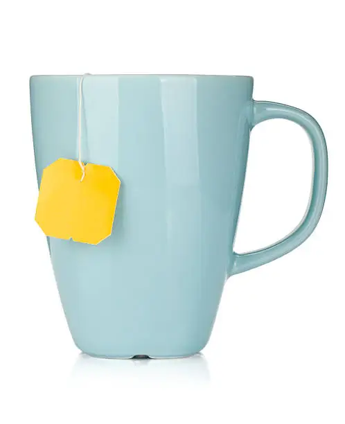 Photo of Blue mug with yellow teabag tag hanging out