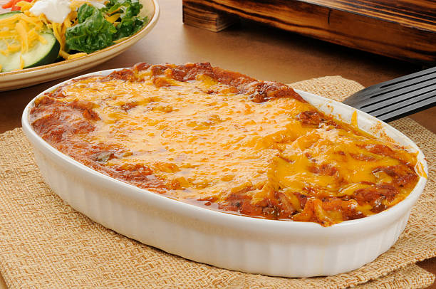 Taco casserole A chicken enchillada casserole topped with cheddar cheese enchilada stock pictures, royalty-free photos & images