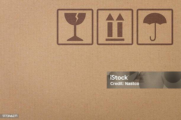 Safety Icons On A Cardboard Box Stock Photo - Download Image Now - Box - Container, Cardboard Box, Textured