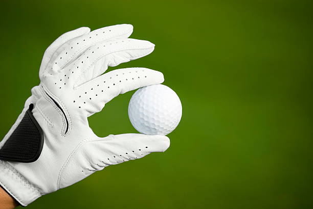 Golf Ball A close up of a golfer holding on a golf ball. golf glove stock pictures, royalty-free photos & images