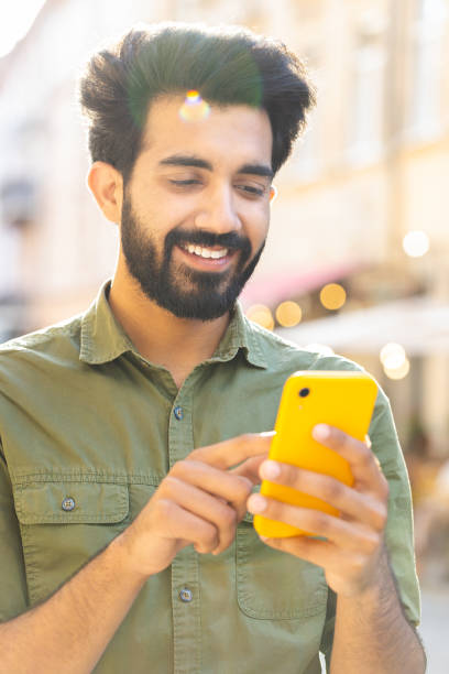istock Indian man use smartphone typing text messages browsing internet finishing work chatting online 1773472328