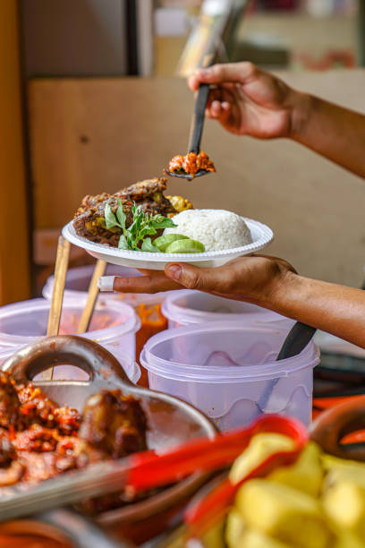 istock The process of adding chili sauce to duck rice and fresh vegetables 1773478468