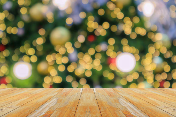 istock Empty wood table top with blur Christmas tree with bokeh light background 1773483978