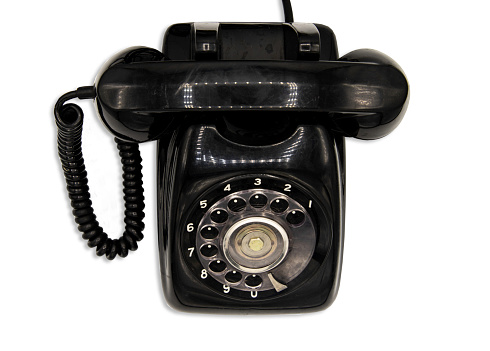 Old black retro rotary Telephone isolated on White background with clipping path. Vintage style.