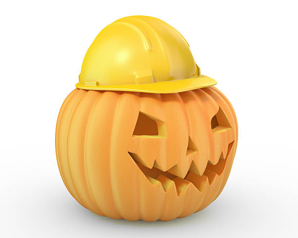 holiday calabaza jack linterna en un casco amarillo - halloween pumpkin jack olantern industry fotografías e imágenes de stock