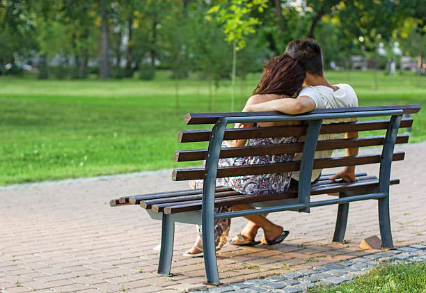 istock Romantic young couple sitting on bench in the park, 177350669