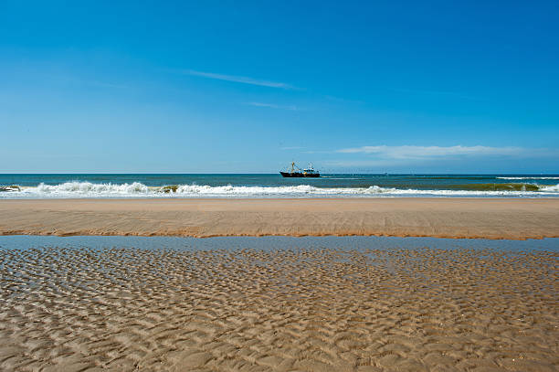istock Trawler fishing at sea under a blue sky 177351463