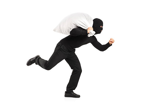 Thief carrying a bag and running away isolated on white background