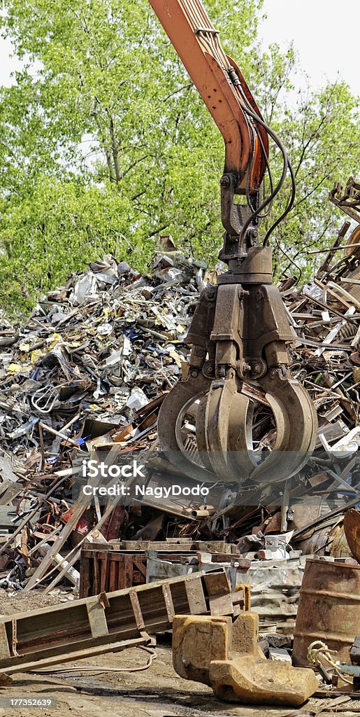 scrap metal grapple inustrial machine with scrap metal grapple in front of scrap iron Adult Stock Photo