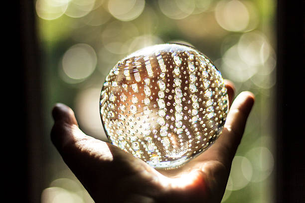 istock shining sphere shaped crystal glass in hand 177352881
