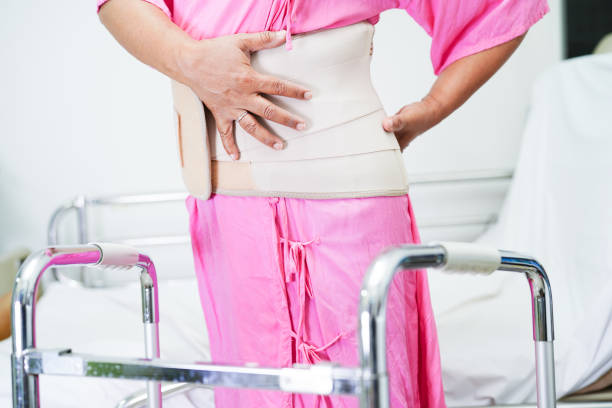 istock Asian senior pain back wearing elastic support belt with walker. 1773528873