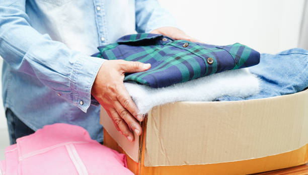 istock Clothes donations in cardboard box for volunteer. 1773528892