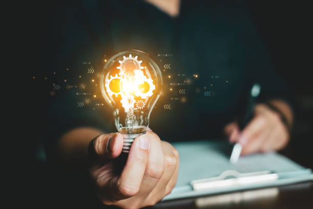 istock Concept Idea and innovation. Business people holding lightbulb. 1773531068