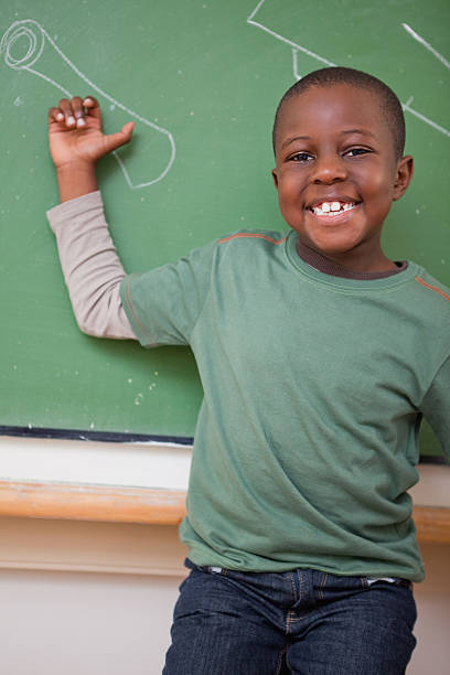 istock Portrait of a schoolboy showing something 177356464